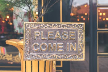 Close Up Photo of Antique Brown Please Come in Sign