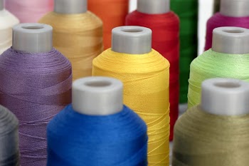Close-Up Photo of Assorted-color Thread Spool