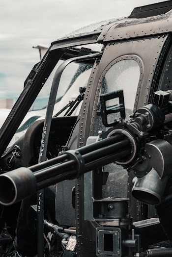Close-up Photo of Black Helicopter With Black Machine Gun