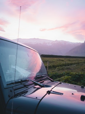 Close-up photo of black vehicle near grass field