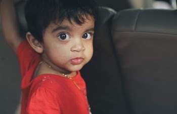 Close-Up Photo of Boy Wearing Red Shirt