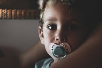 Close-Up Photo of Boy With Pacifier in His Mouth