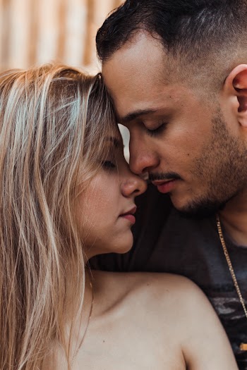 Close-Up Photo of Couple Leaning on Each Other