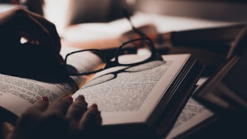 Close-Up Photo Of Eyeglasses On Top Of Book