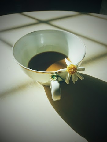 Close-Up Photo of Flower On Cup
