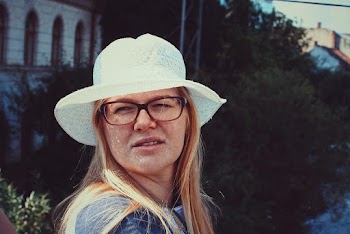 Close-up Photo of Freckled Woman in White Sun Hat and Glasses