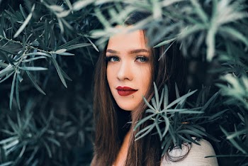 Close-Up Photo of Girl Near Leaves