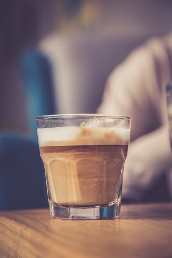 Close-Up Photo of Glass Cup With Coffee on Table