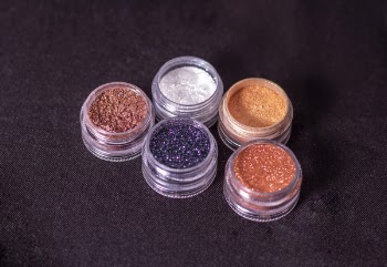 Close-Up Photo of Glitters on Round Containers