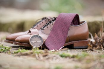 Close-Up Photo of Leather Shoes Near Brown Watch