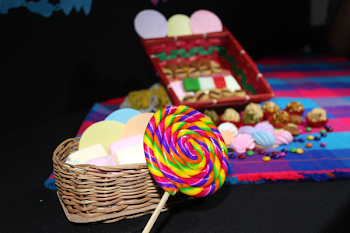 Close Up Photo of Lolipop Beside Woven Basket