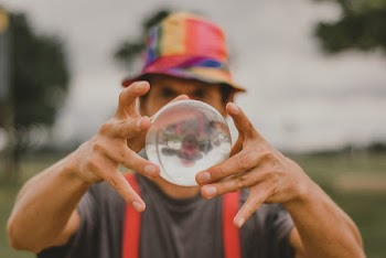 Close-Up Photo of Man Holding Lensball