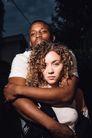 Close-up Photo of Man Hugging Woman from Behind