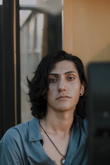 Close-up Photo of Man in a Teal Collared Shirt