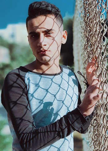 Close-Up Photo of Man Near Chain-Link Fence
