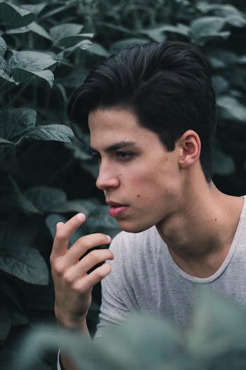 Close-Up Photo of Man Near Leaves