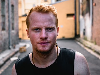 Close-Up Photo of Man Standing in Alley