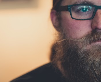 Close-Up Photo of Man Wearing Eyeglasses