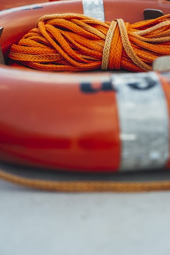 Close-up Photo of Orange Life Ring With Orange Rope
