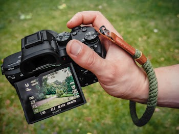 Close-Up Photo of Person Holding Black Camera