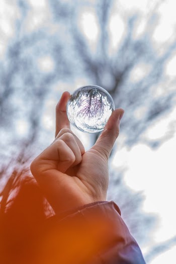 Close-Up Photo of Person Holding Lensball