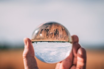 Close-Up Photo of Person Holding Lensball