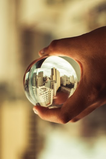 Close-Up Photo of Person Holding Lensball