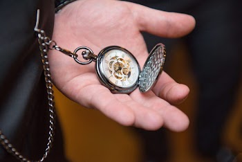 Close-Up Photo of Person Holding Pocket Watch