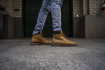 Close-up Photo of Person in a of Pair of Brown Boots and Blue Jeans
