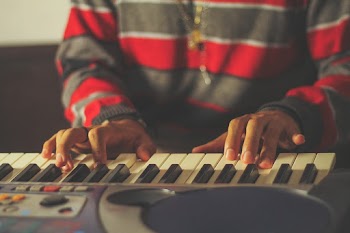 Close-Up Photo of Person Playing Piano