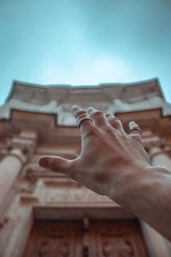 Close-Up Photo of Person Raising His Right Hand