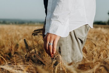 Close-Up Photo of Person Standing on Wheat Field