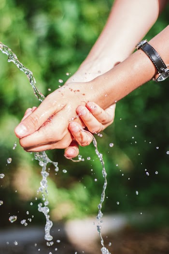 Close-Up Photo of Person Washing Hands on Water
