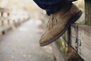 Close-up Photo of Person Wearing Brown Boots