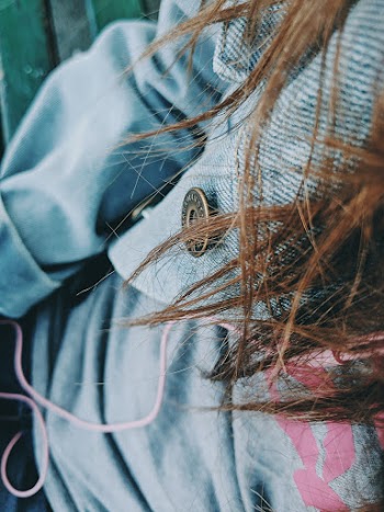 Close-Up Photo of Person Wearing Denim Jacket