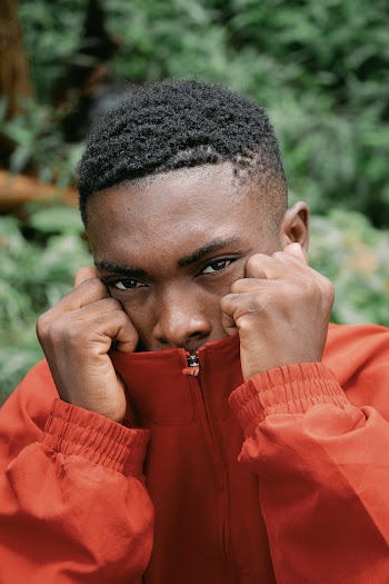 Close-Up Photo of Person Wearing Orange Jacket