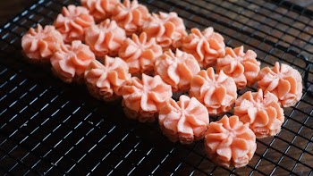 Close-up Photo of Pink Icing on Black Screen