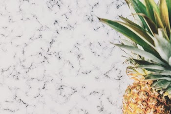 Close-up Photo of Ripe Pineapple Fruit on Marble Surface