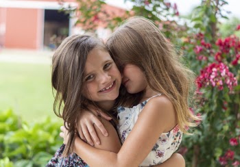Close-Up Photo of Two Little Girls Hugging Each Other