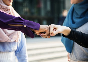 Close-Up Photo of Two People Doing Fist Bump