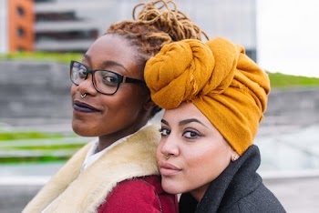 Close-Up Photo of Two Woman Smiling