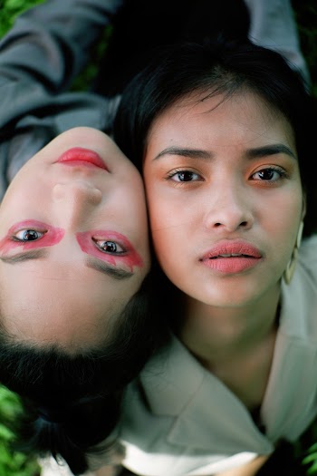 Close-up Photo of Two Women Looking up