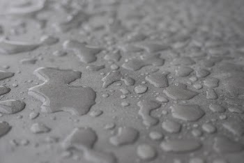 Close-Up Photo of Waters on Grey Surface
