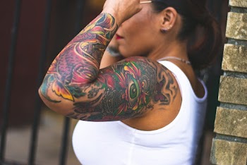 Close-Up Photo of Woman's Arm With Tattoo