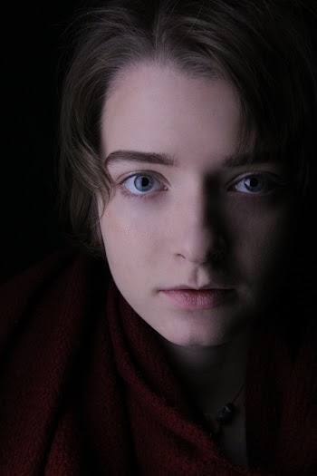 Close-up Photo of Woman's Face Against Dark Background