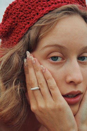 Close-up Photo of Woman's Face Posing With Her Hands On Her Cheeks
