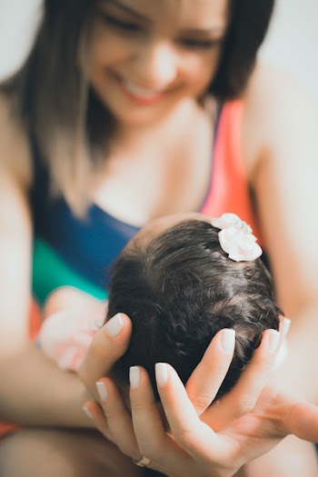 Close-Up Photo of Woman Carrying Baby