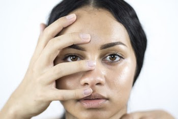 Close-Up Photo of Woman Covering Her Face With Hand