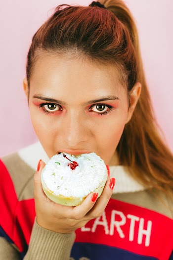 Close-up Photo of Woman Eating Pastry