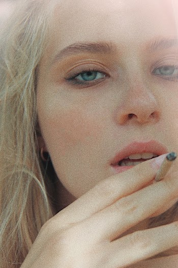 Close-up Photo of Woman Holding a Cigarette